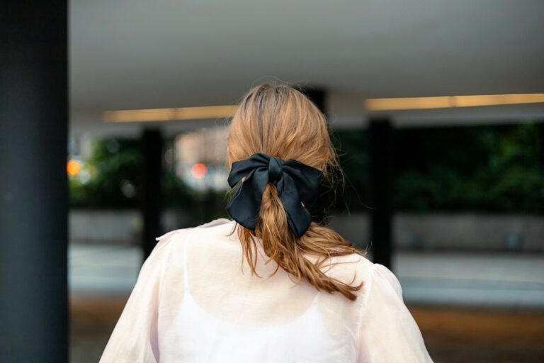 Woman wearing a statement hair bow for fall styling